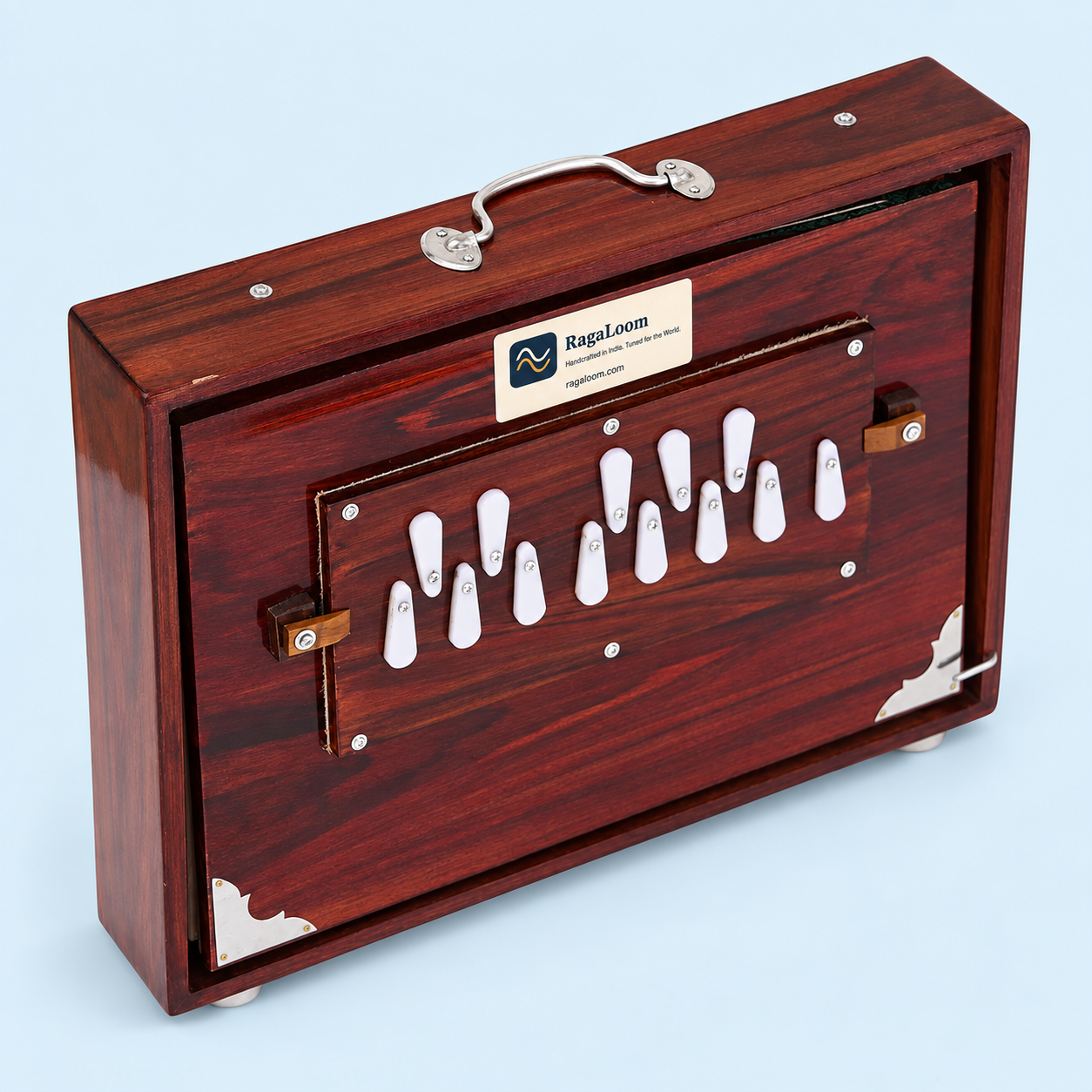 Cherry-finish 16-inch wooden shruti box with 13 notes and RagaLoom label on pale blue background