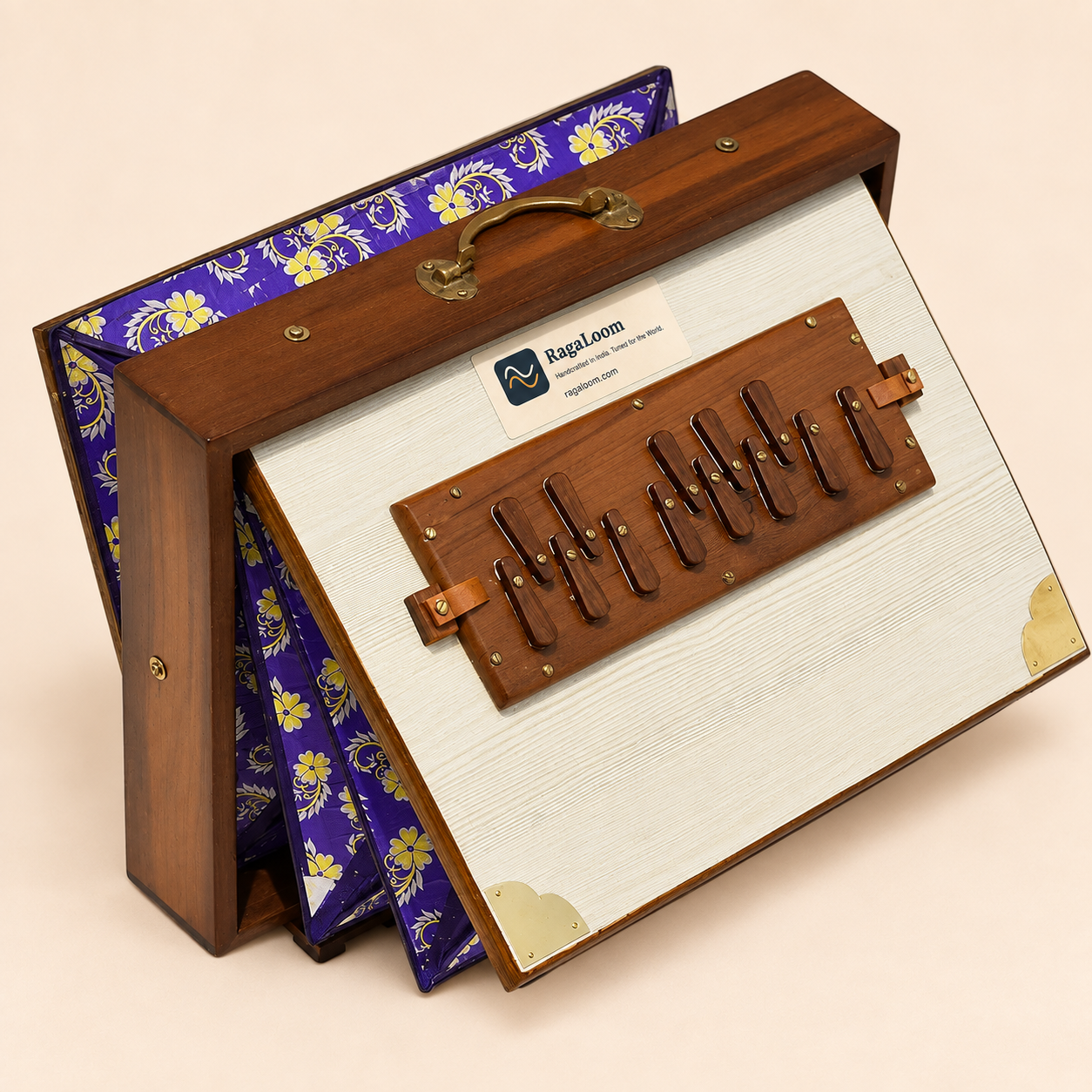 White floral teak shruti box with purple floral bellows open, left angle on pale peach background