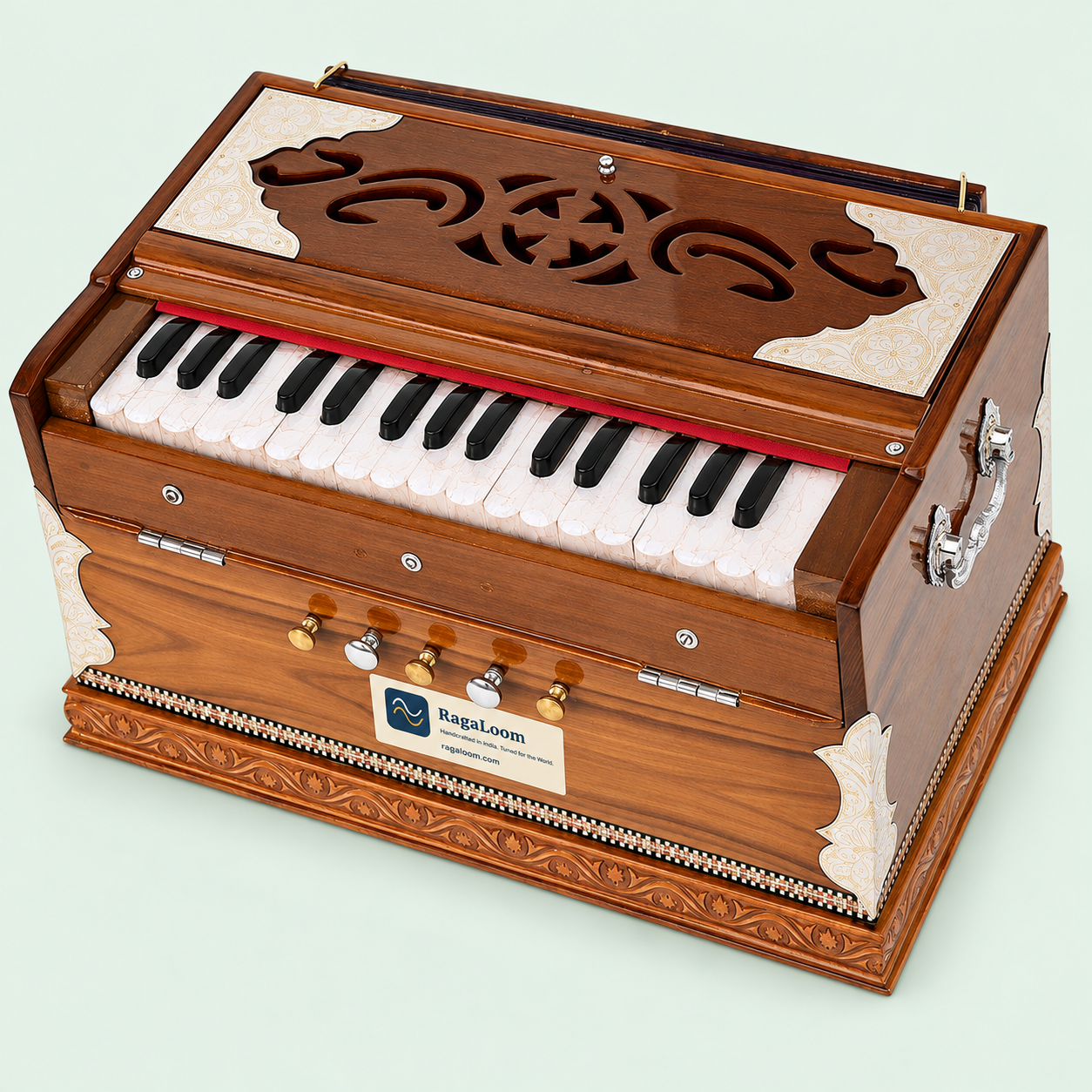 Mini Magic teak harmonium showing the keyboard, four stops and side handle from front-right angle