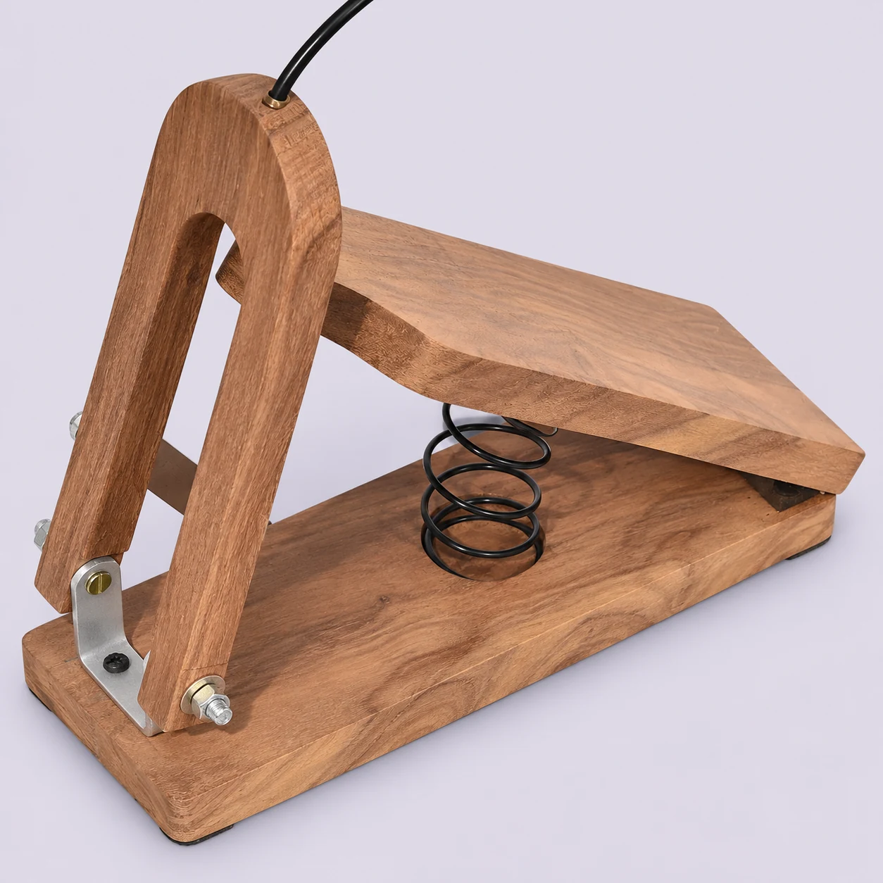 Wooden shruti box foot pedal showing spring and linkage