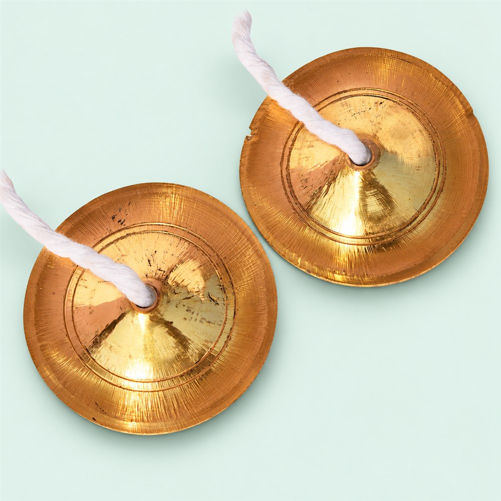 Two 4-inch brass manjira cymbals viewed from the front