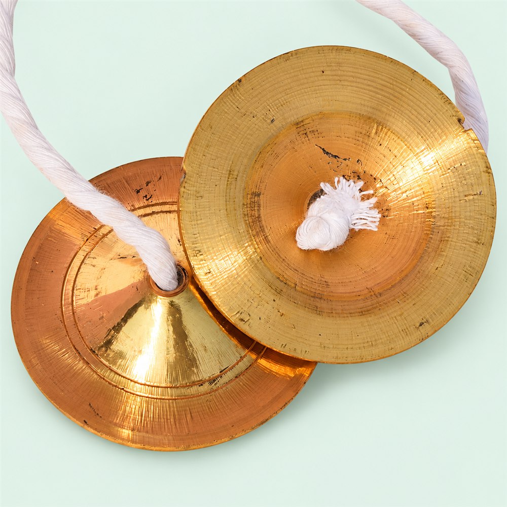 Handcrafted brass manjira pair showing inner and outer cymbal surfaces